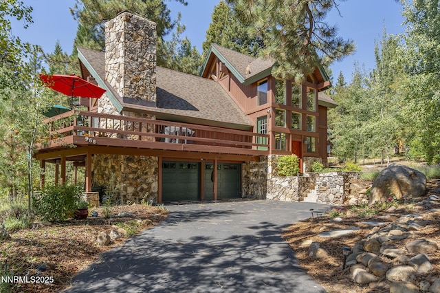 968 Pyrite Ct, Incline Village, NV 89451 - view of front facade with a shingled roof, asphalt driveway, and stone siding