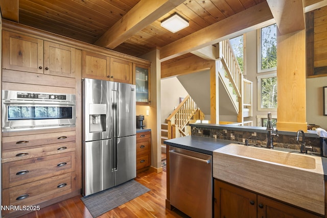 968 Pyrite Ct, Incline Village, NV 89451 - kitchen with appliances with stainless steel finishes, wood ceiling with exposed beams, a sink, light wood-style floors, and glass insert cabinets