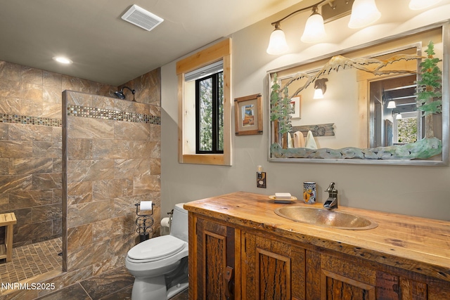 968 Pyrite Ct, Incline Village, NV 89451 - bathroom featuring vanity, tiled shower, toilet, and recessed lighting