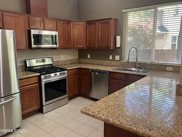 5619 Crescent Hill Way, Sparks, NV 89436 - kitchen featuring appliances with stainless steel finishes, a sink, light tile patterned floors, and brown cabinets