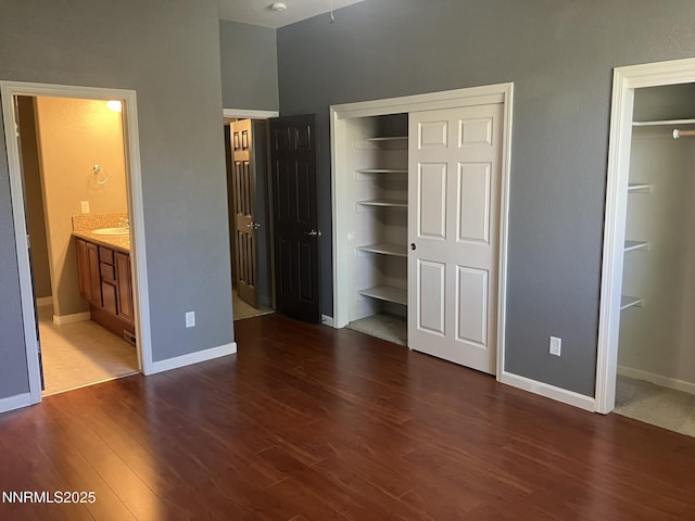 5619 Crescent Hill Way, Sparks, NV 89436 - unfurnished bedroom featuring wood finished floors, baseboards, two closets, and ensuite bath