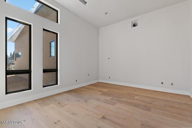 2531 Meraki Pl, Reno, NV 89509 - unfurnished room with light wood-type flooring, baseboards, and vaulted ceiling