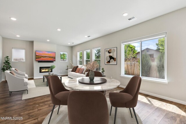 9621 Lane Garrett Dr, Reno, NV 89511 - dining area with baseboards, wood finished floors, a glass covered fireplace, and recessed lighting