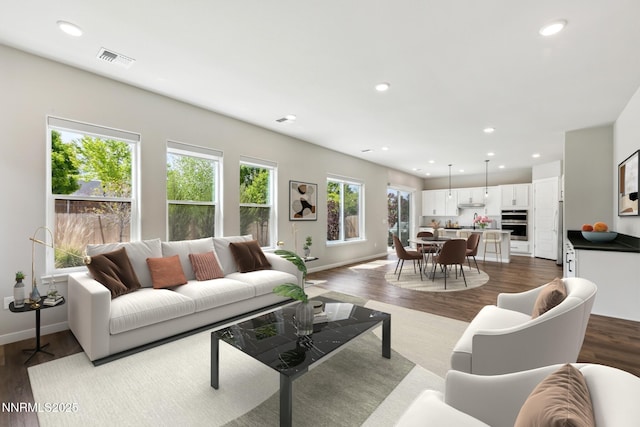 9621 Lane Garrett Dr, Reno, NV 89511 - living room featuring dark wood-type flooring, recessed lighting, and baseboards