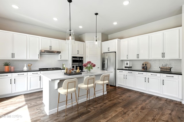 9621 Lane Garrett Dr, Reno, NV 89511 - kitchen featuring appliances with stainless steel finishes, under cabinet range hood, backsplash, white cabinets, and recessed lighting