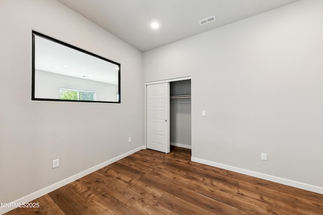9621 Lane Garrett Dr, Reno, NV 89511 - unfurnished bedroom featuring wood finished floors, baseboards, and a closet