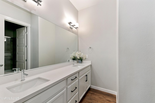9621 Lane Garrett Dr, Reno, NV 89511 - full bath featuring double vanity, wood finished floors, and baseboards