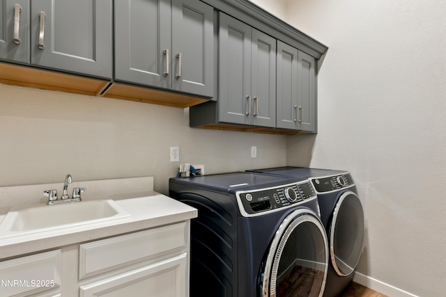 9621 Lane Garrett Dr, Reno, NV 89511 - laundry area with cabinet space, washer and clothes dryer, and baseboards