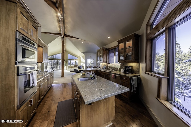 124 Delissa Ct, Stateline, NV 89449 - kitchen featuring a sink, open floor plan, light stone counters, dark wood-type flooring, and glass insert cabinets