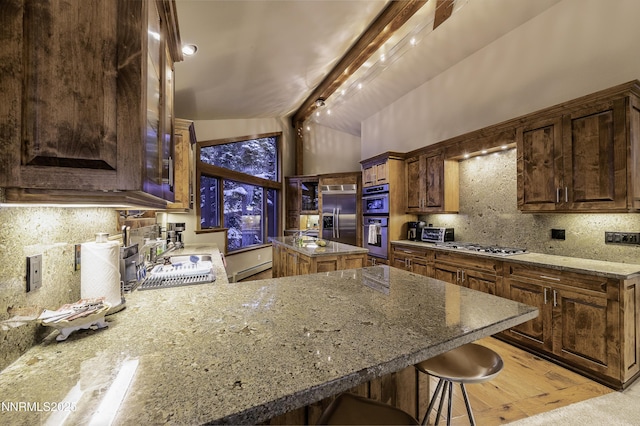 124 Delissa Ct, Stateline, NV 89449 - kitchen featuring stainless steel appliances, tasteful backsplash, glass insert cabinets, a breakfast bar, and vaulted ceiling