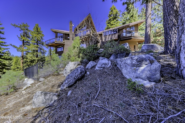124 Delissa Ct, Stateline, NV 89449 - rear view of house with a balcony and a chimney