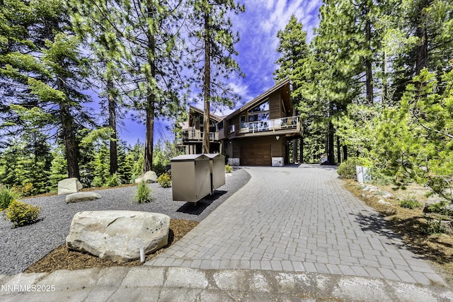 124 Delissa Ct, Stateline, NV 89449 - view of front facade with stone siding, an attached garage, decorative driveway, and a wooden deck