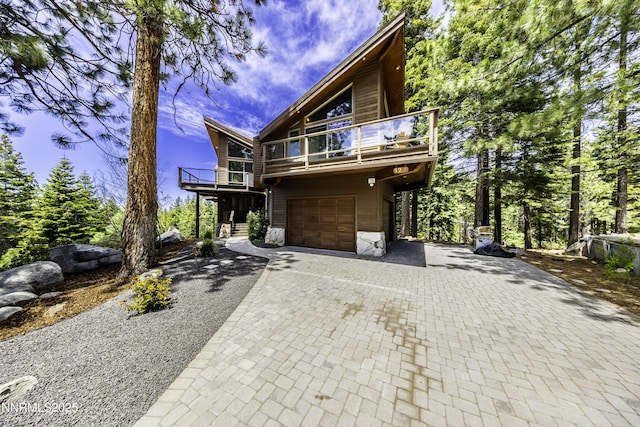 124 Delissa Ct, Stateline, NV 89449 - chalet / cabin featuring a balcony, decorative driveway, and an attached garage