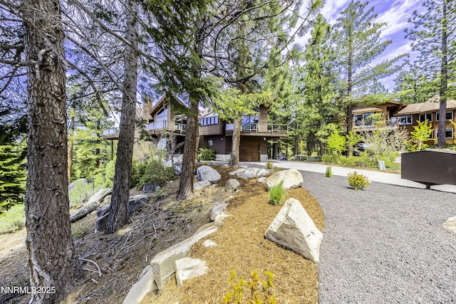 124 Delissa Ct, Stateline, NV 89449 - view of front of house with stone siding, an attached garage, and driveway