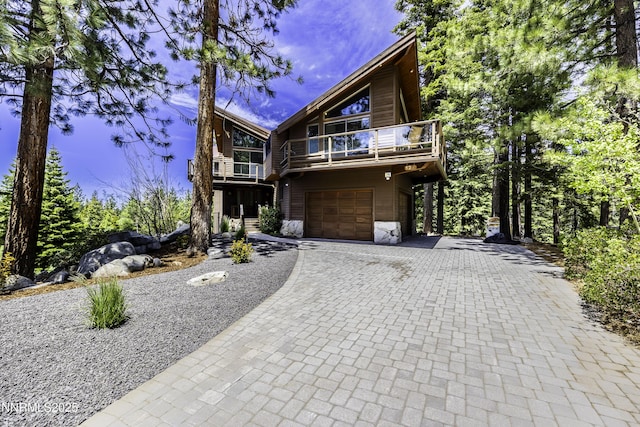 124 Delissa Ct, Stateline, NV 89449 - rustic home featuring a balcony, decorative driveway, an attached garage, and stone siding