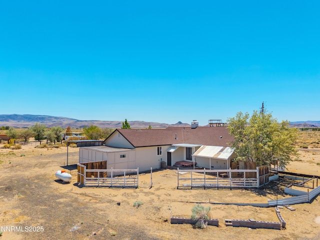 1260 Badger St, Silver Springs, NV 89429 - rear view of property with a mountain view and an outdoor structure