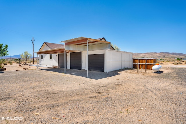 1260 Badger St, Silver Springs, NV 89429 - garage featuring a mountain view and driveway