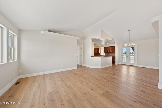 1260 Badger St, Silver Springs, NV 89429 - unfurnished living room with a chandelier, lofted ceiling, light wood-style floors, baseboards, and recessed lighting