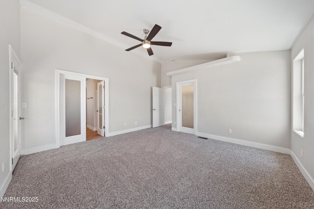 1260 Badger St, Silver Springs, NV 89429 - unfurnished bedroom featuring carpet flooring, baseboards, ceiling fan, and vaulted ceiling