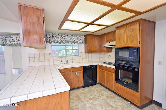 1664 Shadow Wood Rd, Reno, NV 89523 - kitchen featuring black appliances, brown cabinets, tile counters, and backsplash