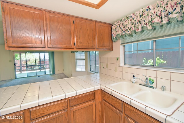 1664 Shadow Wood Rd, Reno, NV 89523 - kitchen featuring a peninsula, brown cabinets, and backsplash