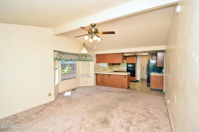1664 Shadow Wood Rd, Reno, NV 89523 - kitchen featuring brown cabinetry, black appliances, a peninsula, light countertops, and light carpet