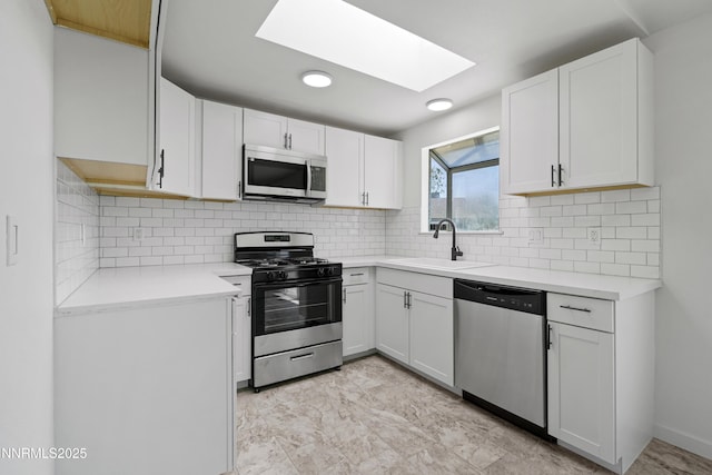266 River Boat Rd, Dayton, NV 89403 - kitchen featuring stainless steel appliances, a sink, a skylight, light countertops, and white cabinets