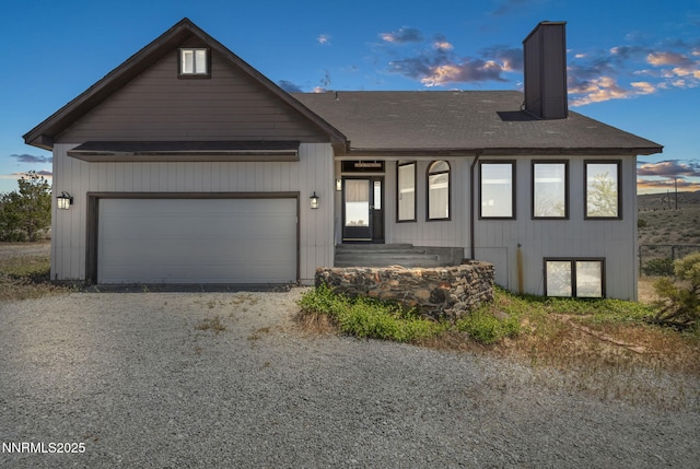 670 Valle Verde Dr, Sparks, NV 89441 - view of front of house with a chimney, driveway, a shingled roof, and a garage