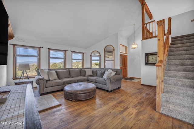 670 Valle Verde Dr, Sparks, NV 89441 - living area with hardwood / wood-style floors, healthy amount of natural light, stairway, high vaulted ceiling, and baseboards
