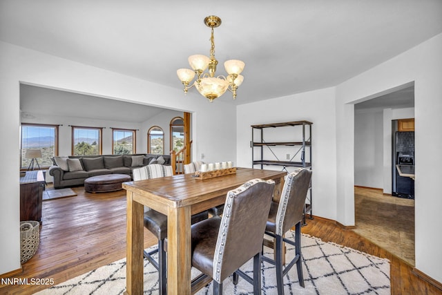 670 Valle Verde Dr, Sparks, NV 89441 - dining space with a chandelier, wood finished floors, and baseboards