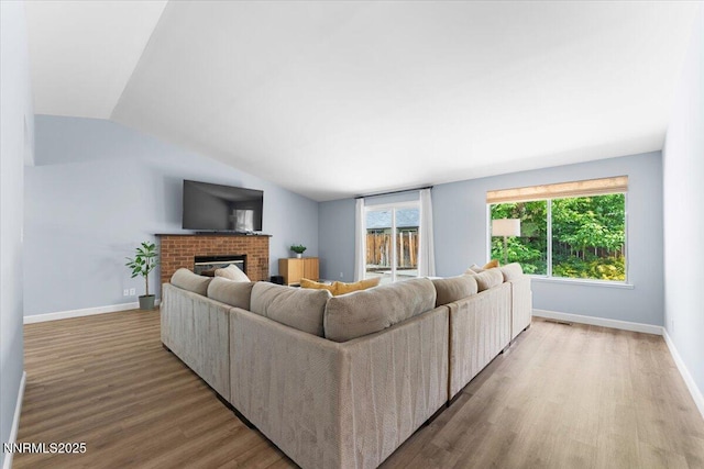 1832 Espee Ct, Sparks, NV 89434 - living area featuring wood finished floors, a fireplace, baseboards, and vaulted ceiling