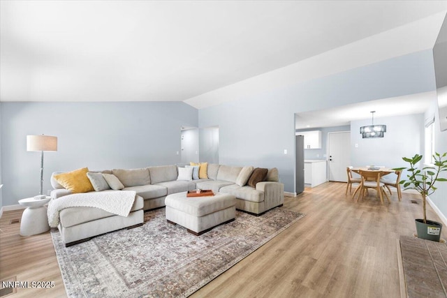 1832 Espee Ct, Sparks, NV 89434 - living area with light wood finished floors, a chandelier, baseboards, and vaulted ceiling