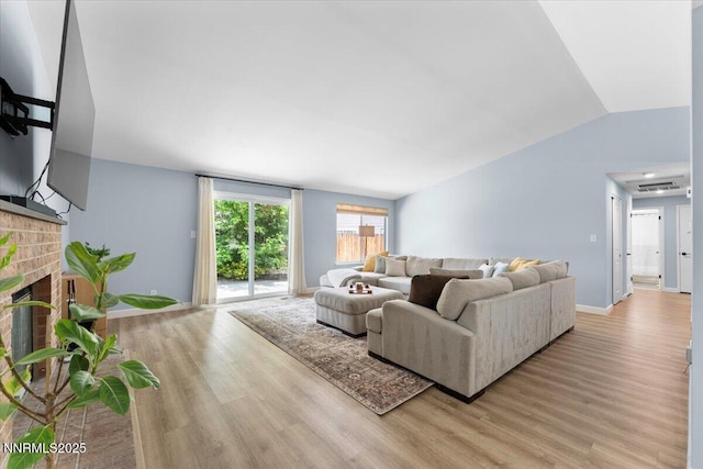 1832 Espee Ct, Sparks, NV 89434 - living room with light wood-style floors, lofted ceiling, a fireplace, and baseboards