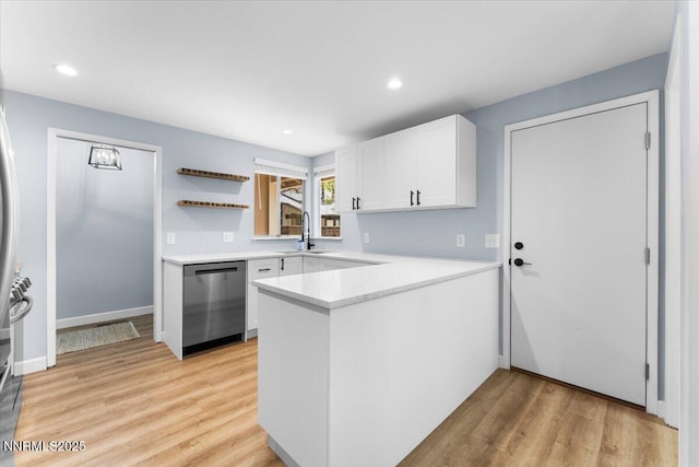 1832 Espee Ct, Sparks, NV 89434 - kitchen with stainless steel dishwasher, a peninsula, a sink, white cabinetry, and light countertops