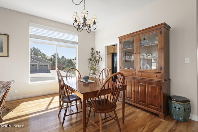 7100 Heatherwood Dr, Reno, NV 89523 - dining space with a chandelier, light wood-type flooring, and baseboards