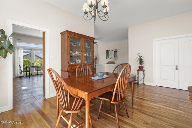 7100 Heatherwood Dr, Reno, NV 89523 - dining space with a chandelier, light wood-style floors, and baseboards