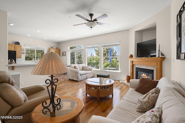 7100 Heatherwood Dr, Reno, NV 89523 - living area with a fireplace, light wood-style flooring, a ceiling fan, recessed lighting, and baseboards
