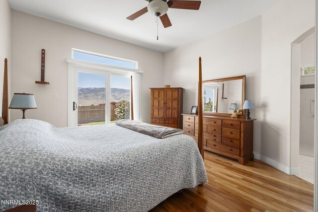 7100 Heatherwood Dr, Reno, NV 89523 - bedroom featuring access to outside, wood finished floors, baseboards, a mountain view, and ceiling fan