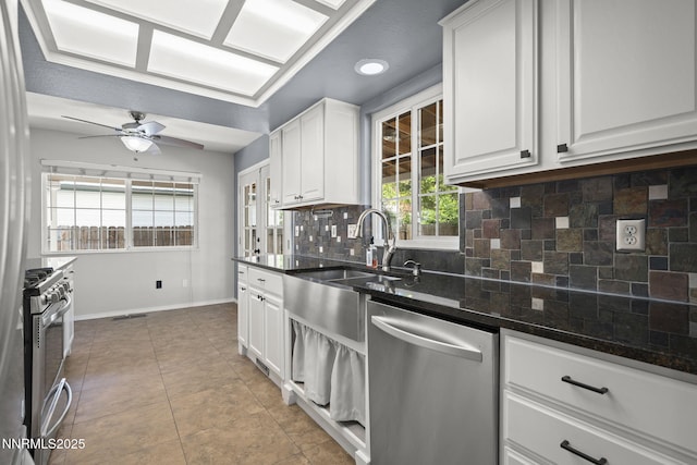 2125 Woodhaven Ln, Sparks, NV 89434 - kitchen featuring appliances with stainless steel finishes, baseboards, tasteful backsplash, a sink, and white cabinetry