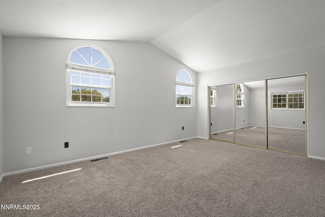 2125 Woodhaven Ln, Sparks, NV 89434 - unfurnished bedroom with vaulted ceiling, carpet flooring, baseboards, and a closet