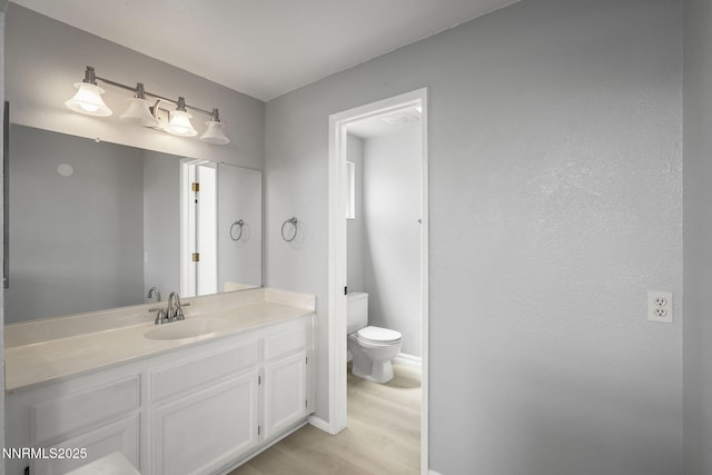 2125 Woodhaven Ln, Sparks, NV 89434 - bathroom featuring toilet, vanity, wood finished floors, and baseboards