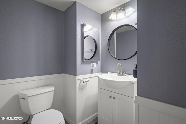 2125 Woodhaven Ln, Sparks, NV 89434 - bathroom with toilet, a wainscoted wall, vanity, and a textured wall