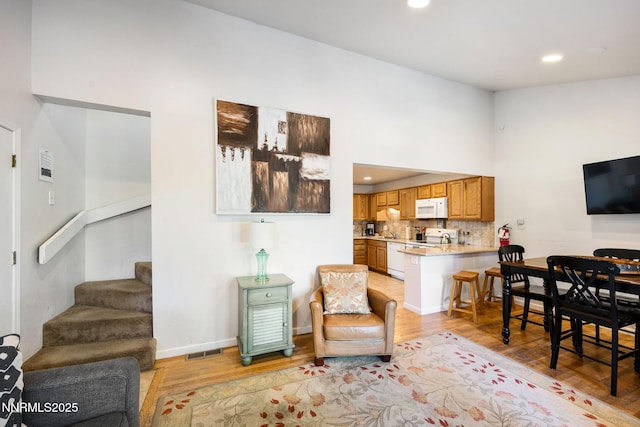 223 Ski Ct # B, Stateline, NV 89449 - living area with light wood-style floors, stairway, recessed lighting, baseboards, and a high ceiling