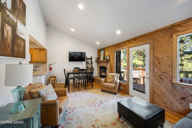 223 Ski Ct # B, Stateline, NV 89449 - living room featuring recessed lighting, vaulted ceiling, a fireplace, wooden walls, and light wood finished floors
