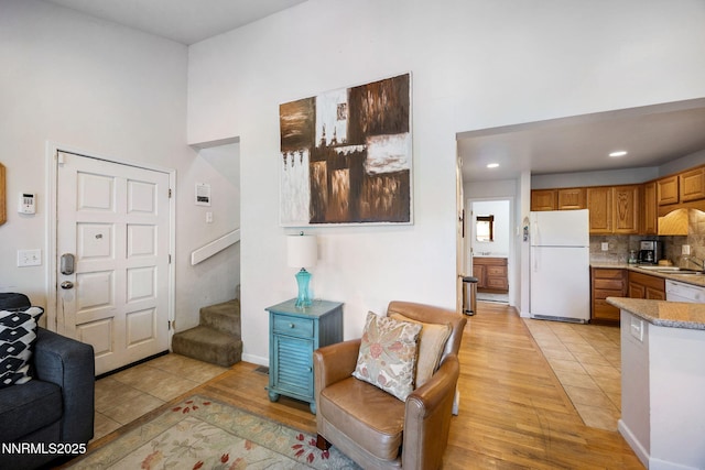 223 Ski Ct # B, Stateline, NV 89449 - living area featuring stairs, light wood-style flooring, a high ceiling, and recessed lighting