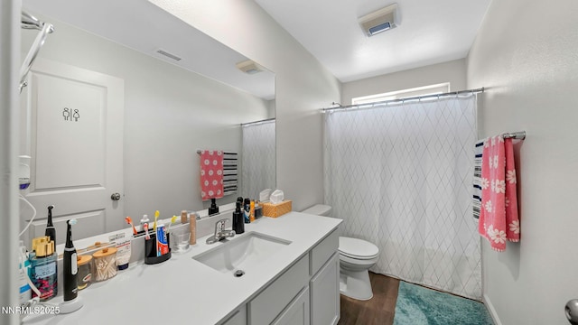 640 Mcgill Dr, Reno, NV 89506 - full bathroom featuring toilet, vanity, a shower with shower curtain, and wood finished floors