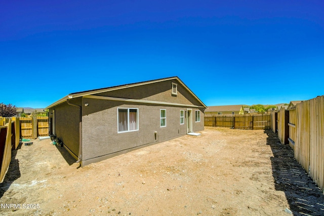 640 Mcgill Dr, Reno, NV 89506 - rear view of property featuring stucco siding and a fenced backyard