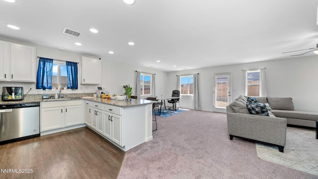 640 Mcgill Dr, Reno, NV 89506 - kitchen featuring dishwasher, a peninsula, a sink, open floor plan, and white cabinetry