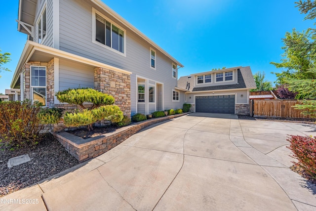 1011 Keystone Ct, Gardnerville, NV 89460 - view of front of property featuring stone siding, concrete driveway, and a garage