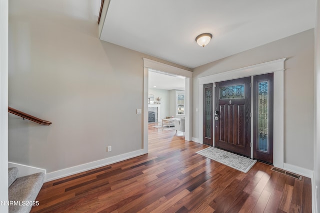 1011 Keystone Ct, Gardnerville, NV 89460 - entrance foyer with wood finished floors, stairway, baseboards, and a fireplace